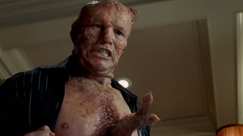 Michel Rooker as Grant, covered in boils with tentacles sprouting from his chest, in Slither