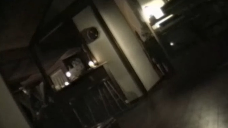 A figure stands in the hallway of an empty home in The McPherson Tape