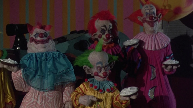 Four killer clowns holding pies from Killer Klowns From Outer Space
