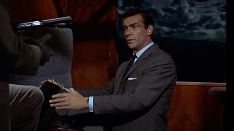 Sean Connery as James Bond holds open a briefcase in From Russia with Love