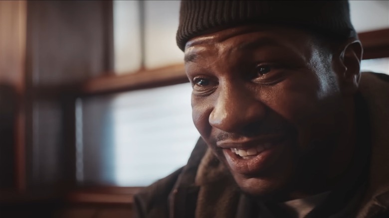 Jonathan Majors smiling watery eyes