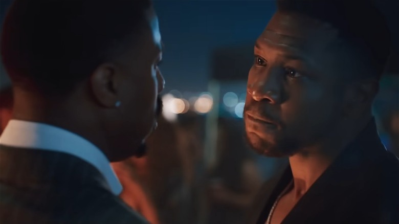 Jonathan Majors staring at Michael B Jordan