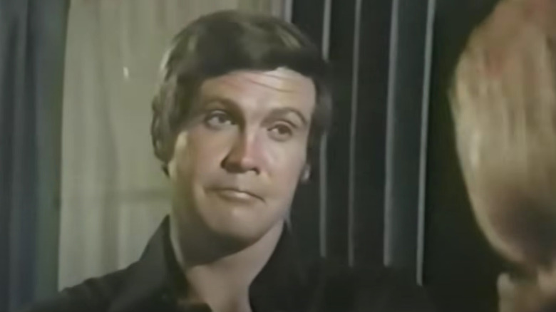 Lee Majors as Jess Brandon talking to a woman in Owen Marshall Counselor at Law