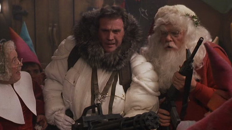 Jean Howard as Mrs. Claus, Lee Majors as himself, and Al Weber as Santa, preparing for war in Scrooged