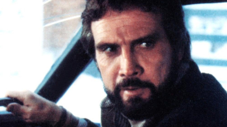 Lee Majors as Philip Morgan driving a car in The Agency