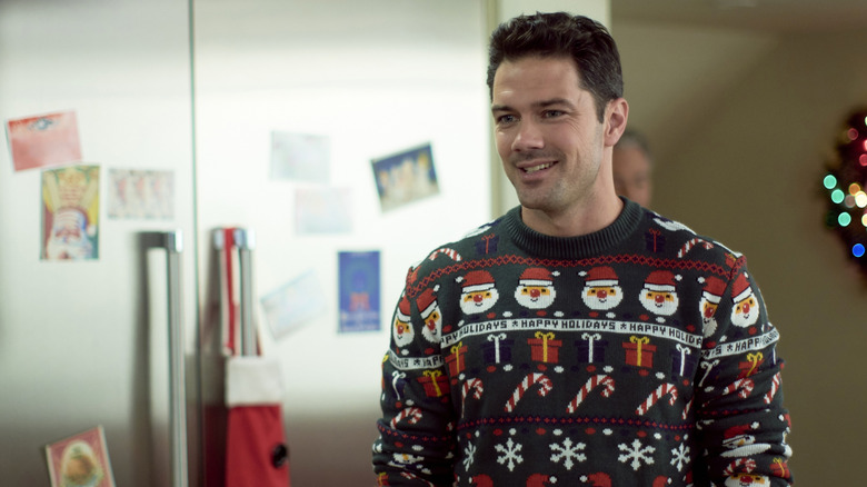 Nick wearing Christmas sweater in Christmas at the Plaza