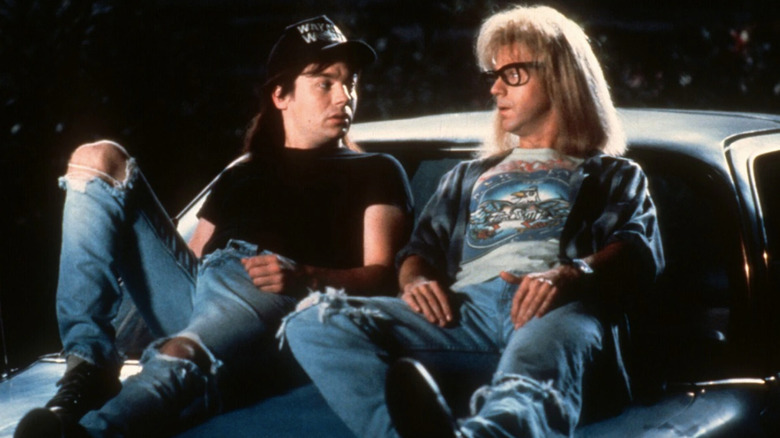 Wayne's World's Mike Myers and Dana Carvey sit on car