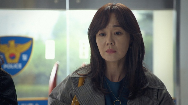 Ma Ji-won (Yunjin Kim) stands contemplatively in a police station in Ms. Ma, Nemesis