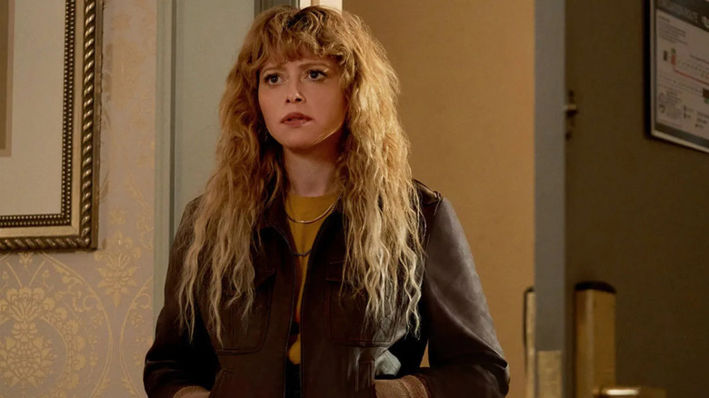 Charlie Cale (Natasha Lyonne) stands looking determined in Poker Face