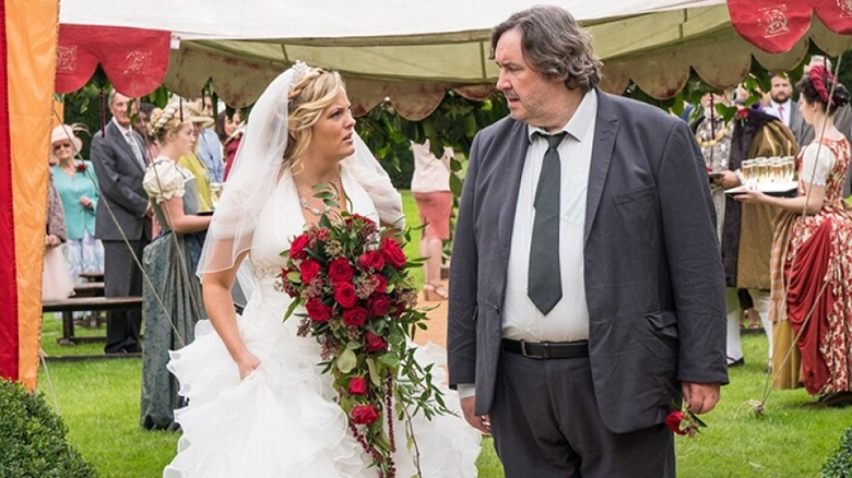 Luella Shakespeare (Jo Joyner) glares at Frank Hathaway (Mark Benton) while wearing a wedding dress in Shakespeare & Hathaway: Private Investigators