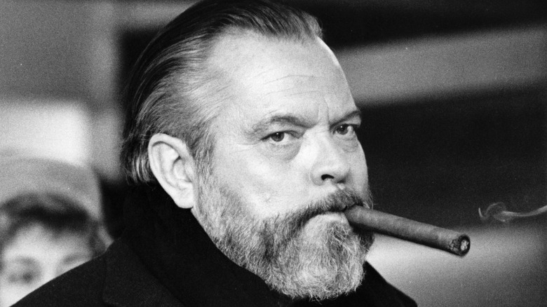 Orson Welles smokes a cigar