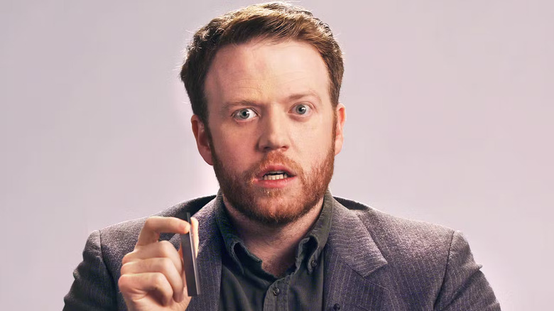 Brennan Lee Mulligan as the Juul CEO holding a vape pen in A Message from the CEO