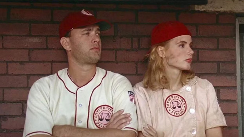 Tom Hanks as Jimmy Dugan sits next to Genna Davis as Dottie in A League of Their Own