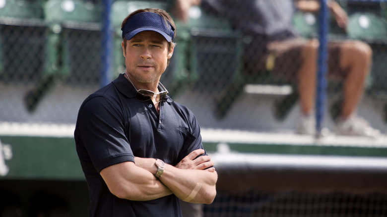 Brad Pitt as Billy Beane watches a baseball game in Moneyball