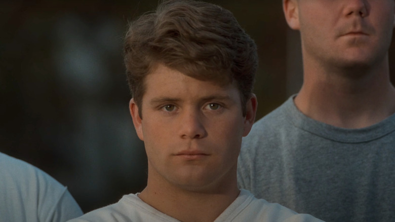 Sean Astin as Rudy stands next to his fellow players in Rudy