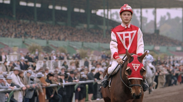 Tobey Maguire as John "Red" Pollard sits on top of Seabiscuit in Seabiscuit
