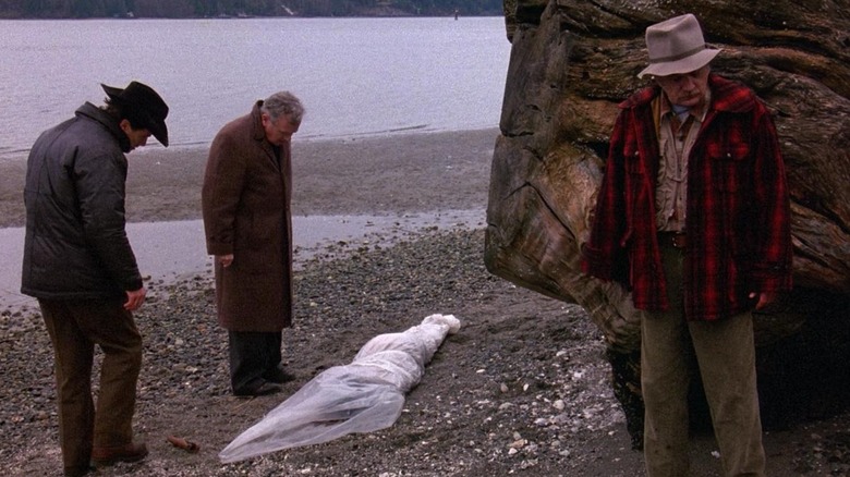 Sheriff Truman observes the body of Laura Palmer