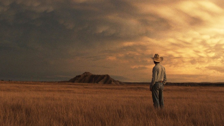 Cowboy stares into sunset