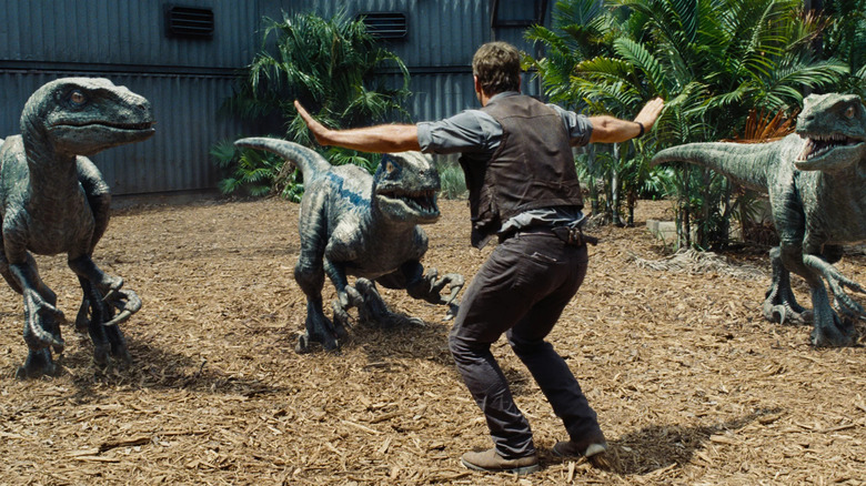 Jurassic World owen holds back raptors