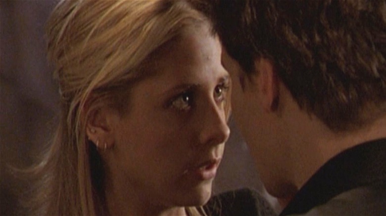 Buffy's Buffy Summers with head close to Angel's