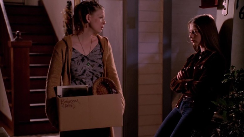 Buffy's Tara walking out of the house with box while Dawn stands by