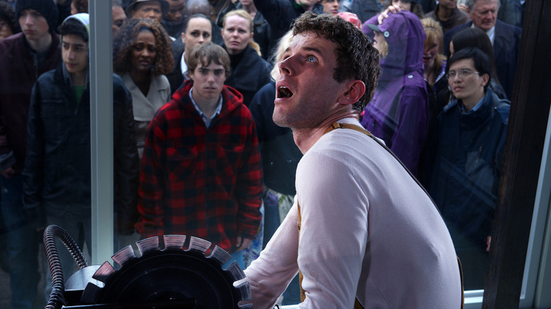 A crowd watches Jigsaw's most public trap
