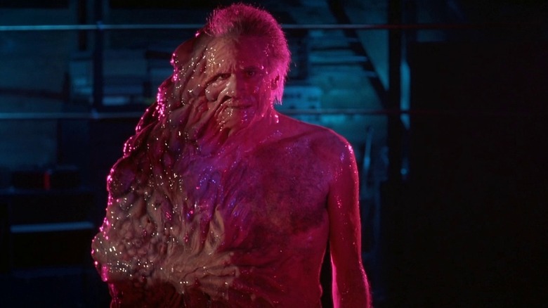 Ted Sorel as Dr. Edward Pretorius in From Beyond, half mutated into a gross monster.