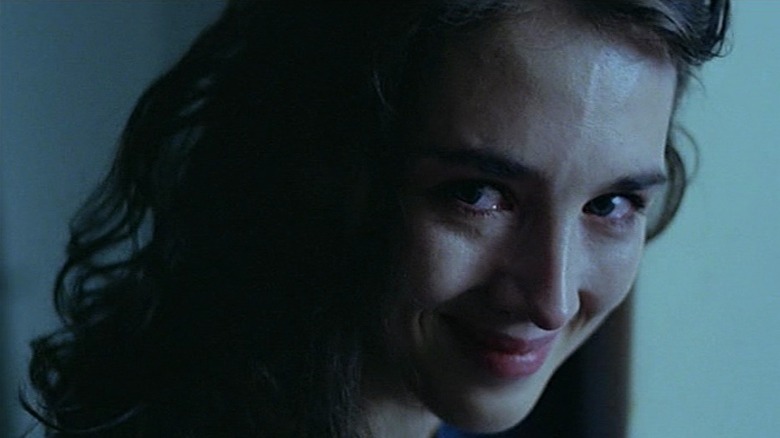 Isabelle Adjani as Helen in Possession, looking at something out of frame with a smile and on the verge on tears.