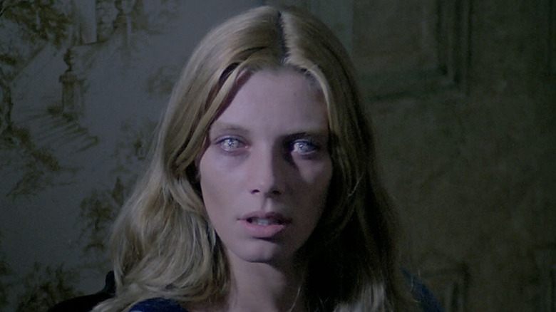 Cinzia Monreale as Emily in The Beyond, her eyes glazed over and looking at something out of frame.