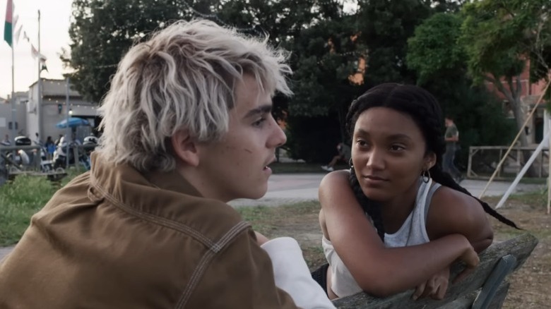Jack Dylan Grazer as Fraser Wilson and Jordan Kristine Seamón as Caitlin Poythress sitting on a bench and talking on We Are Who We Are
