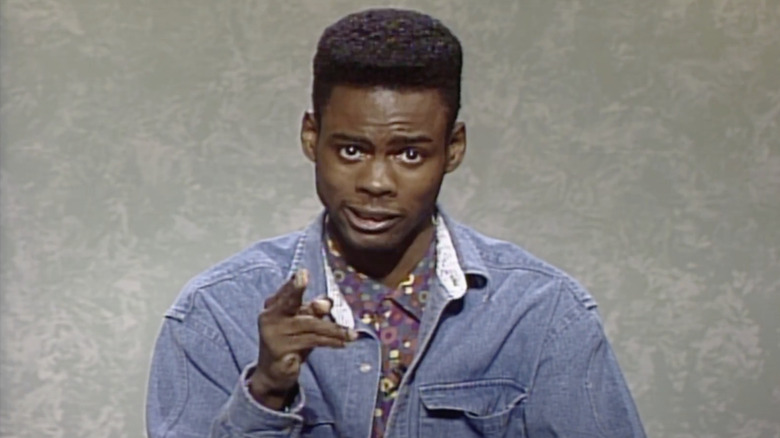 Chris Rock pointing at the camera in a Weekend Update feature on SNL