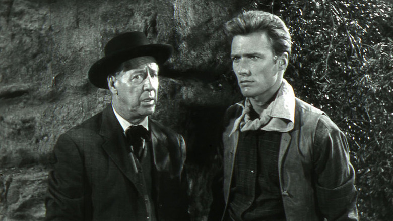 Stanfield (Irving Bacon) stands next to a stoic Keith Williams (Clint Eastwood) in Ambush at Cimarron Pass
