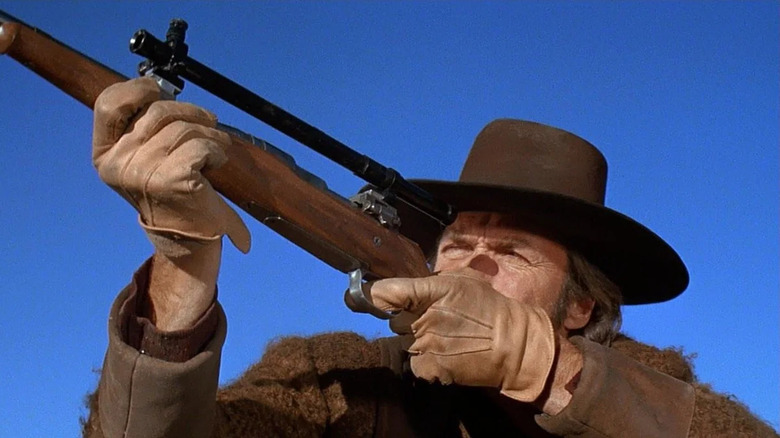 Joe Kidd (Clint Eastwood) aims through a rifle scope in Joe Kidd