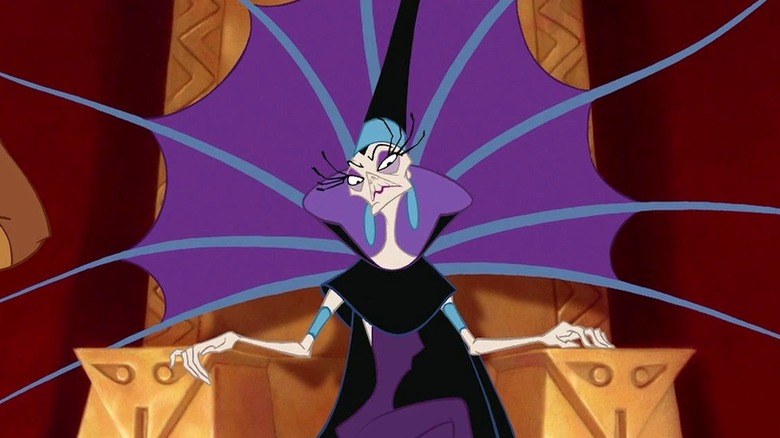 Yzma sits on a gold thrown while wearing a purple dress with black accents while looking ahead in The Emperor's New Groove