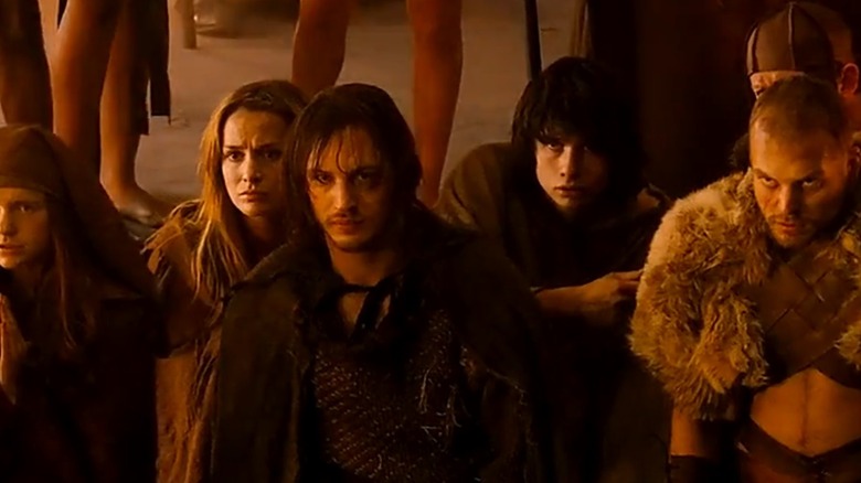 Tom Hardy, as Theo, is taking his emo friends to hunt the Minotaur.
