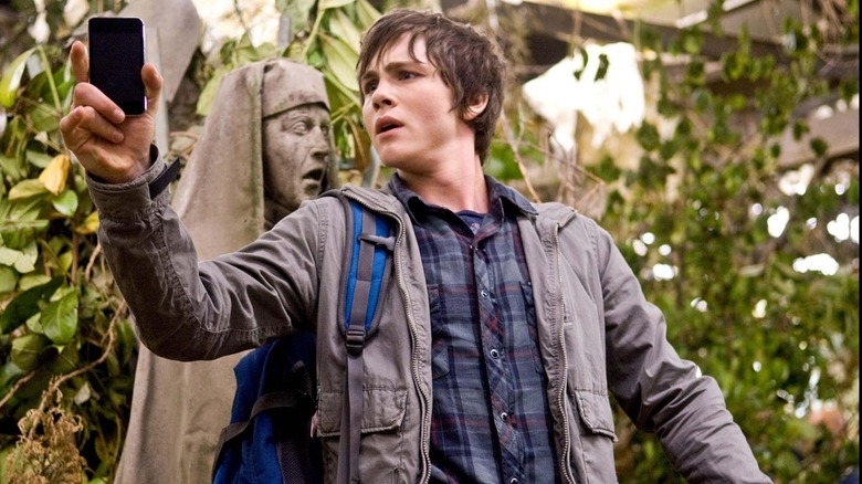 Logan Lerman, as Percy, wields a cell phone in The Lightning Thief