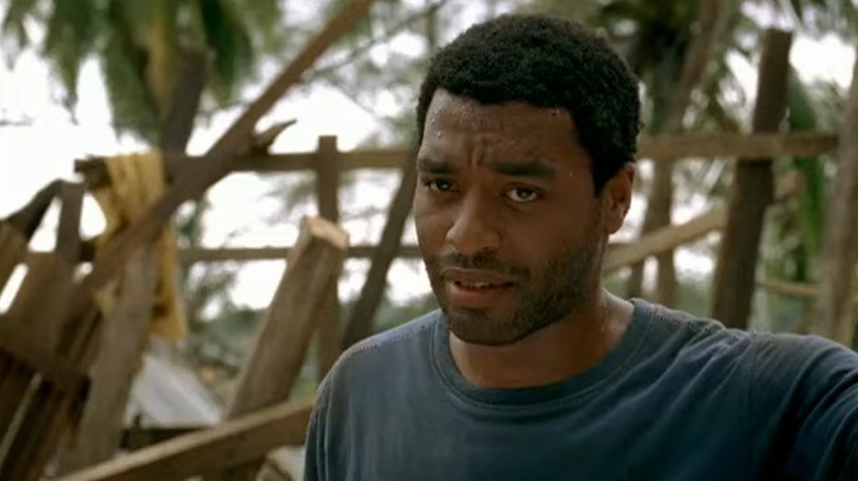 Chiwetel Ejiofor as Ian Carter surrounded by debris on Tsunami: The Aftermath