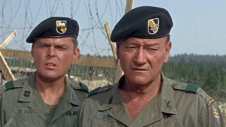 John Wayne as Col. Mike Kirby with Edward Faulkner Capt. MacDaniel, each looking vaguely concerned off frame in The Green Berets.