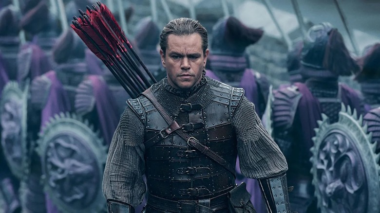 Matt Damon, as westerner Will Garin, stands ready amidst purple warriors in The Great Wall