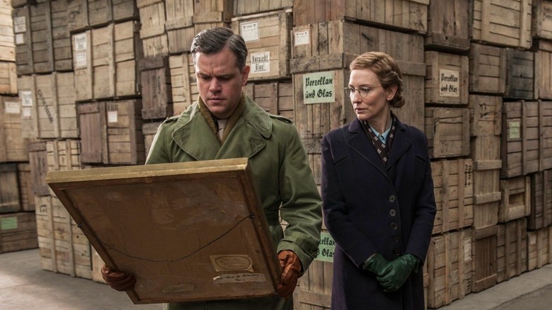 Matt Damon as James Granger and Cate Blanchett as Claire Simone examine rescued art in The Monuments Men
