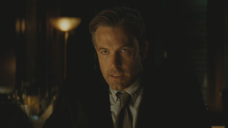 Bruce Wayne (Ben Affleck) sitting at a table in Suicide Squad