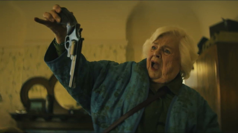 June Squibb holding a gun in fear in Thelma