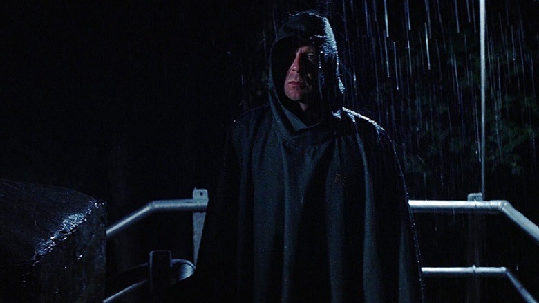 David Dunn in the rain with a hood on