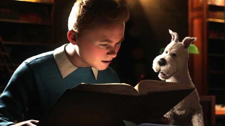 Tintin and his dog Snowy look at a book in a library in The Adventures of Tintin