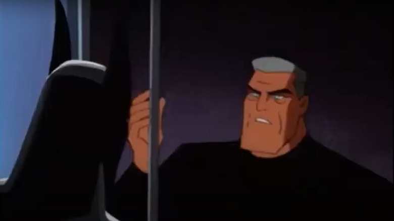 Bruce Wayne looking at Batsuit