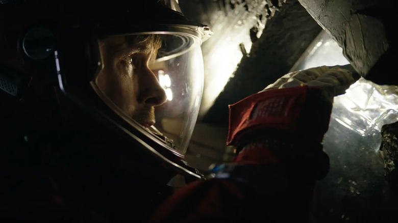 Ryan Gosling as Ryland Grace inspecting the interior of a strange spacecraft in Project Hail Mary