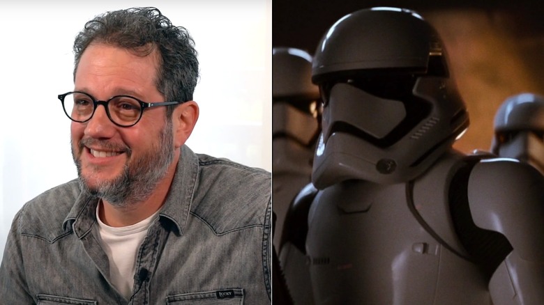 Michael Giacchino in front of a white wall next to FN-3181 on Tanuul in Star Wars: The Force Awakens (2015)