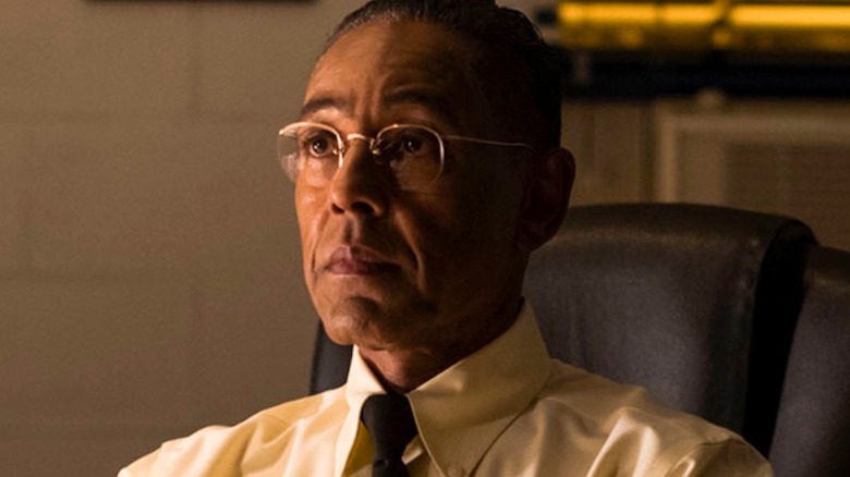 Gus Fring sits in office chair