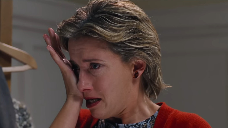 Emma Thompson as Karen blotting her tears with the palm of her hand in Love, Actually