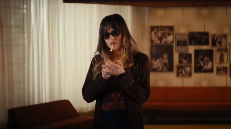 Emily lighting cigarette in Bad Times at the El Royale